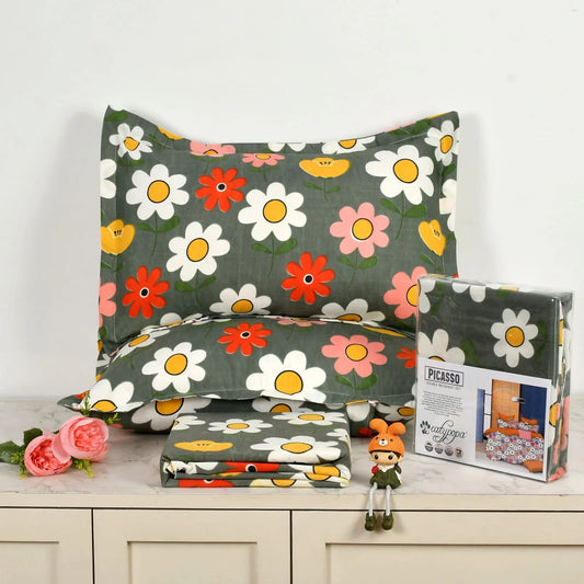 Charcoal grey bedsheet set with colorful daisy flower pattern in white, pink, red and yellow - Picasso collection 3PC cotton bedding set with retro floral design by Towelleo.com displayed on white dresser with decorative flowers and packaging
