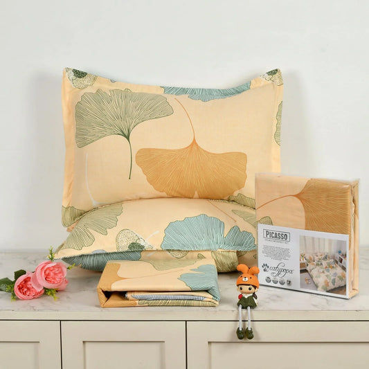 Ginkgo leaf pattern bedsheet set in cream and green colors - Picasso collection 3PC cotton bedding set with botanical design by Towelleo.com displayed on white dresser with decorative flowers and packaging
