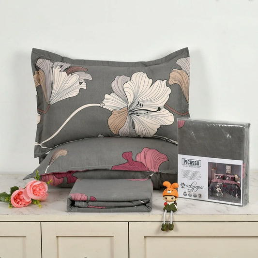 Grey bedsheet set with large pink and beige hibiscus flower pattern - Picasso collection 3PC cotton bedding set with tropical floral design by Towelleo.com displayed on white dresser with decorative flowers and packaging
