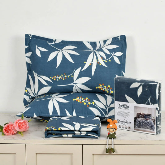Navy blue bedsheet set with white botanical leaf pattern and colorful berries - Picasso collection 3PC cotton bedding set by Towelleo.com displayed on white dresser with decorative flowers and packaging
