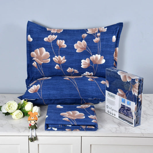 Royal blue bedsheet set with pink magnolia flower pattern on textured fabric - Picasso collection 3PC cotton bedding set with elegant floral design by Towelleo.com displayed on white dresser with decorative flowers and packaging
