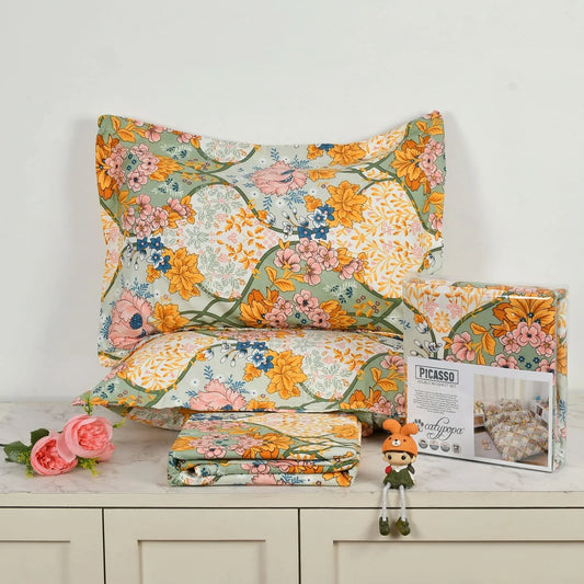 Vintage floral bedsheet set with colorful garden pattern in orange, pink and green - Picasso collection 3PC cotton bedding set by Towelleo.com displayed on white dresser with decorative flowers and packaging
