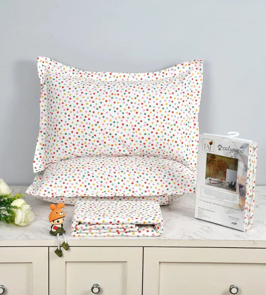 Polka dot pillowcases and fabric on a dresser with a magazine.