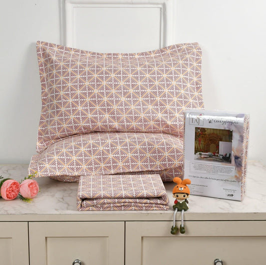 Patterned bedding set with a pillow and folded sheet on a surface, accompanied by a toy and product packaging towelleo.com